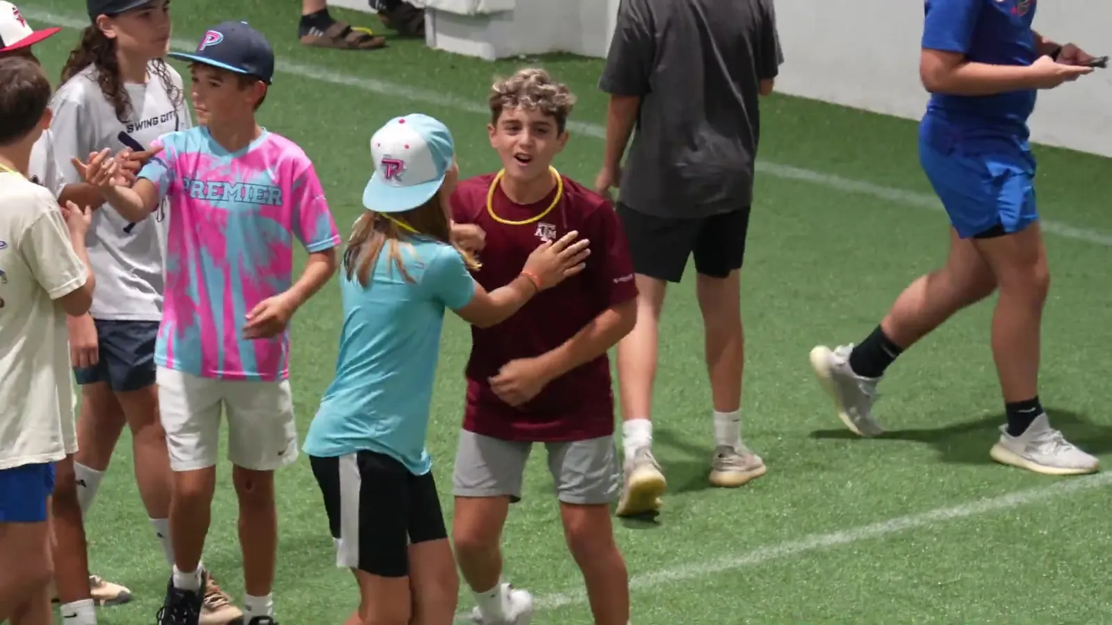 A group of kids celebrating on the indoor field at The Hattrick Houston